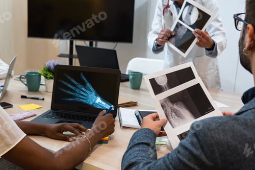 Preview: Crop doctors examining x rays in clinic