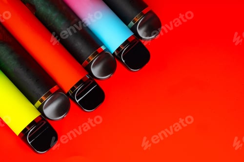 Preview: Colorful disposable electronic cigarettes on red background