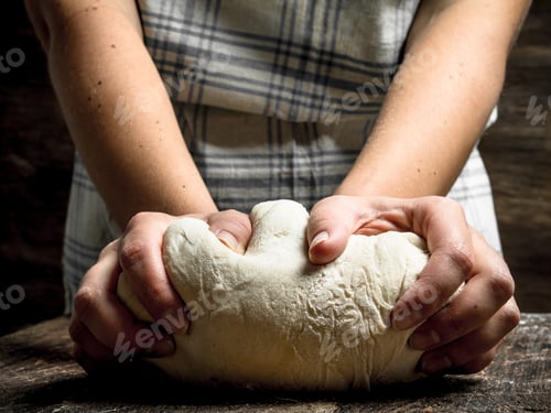 Preview: Dough background. A woman is preparing a dough.