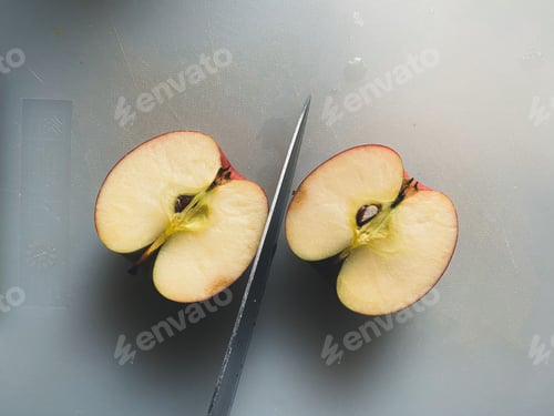 Preview: Sliced Apple on a Cutting Board with Knife