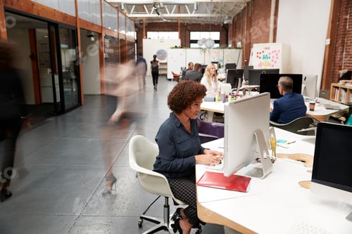 Preview: Business Team Working At Desks In Modern Open Plan Office