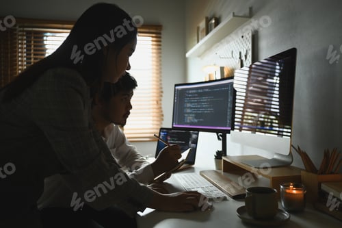 Preview: Young professionals team working in software development in dark home office