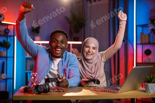 Preview: Diverse couple feeling happiness while win in video games