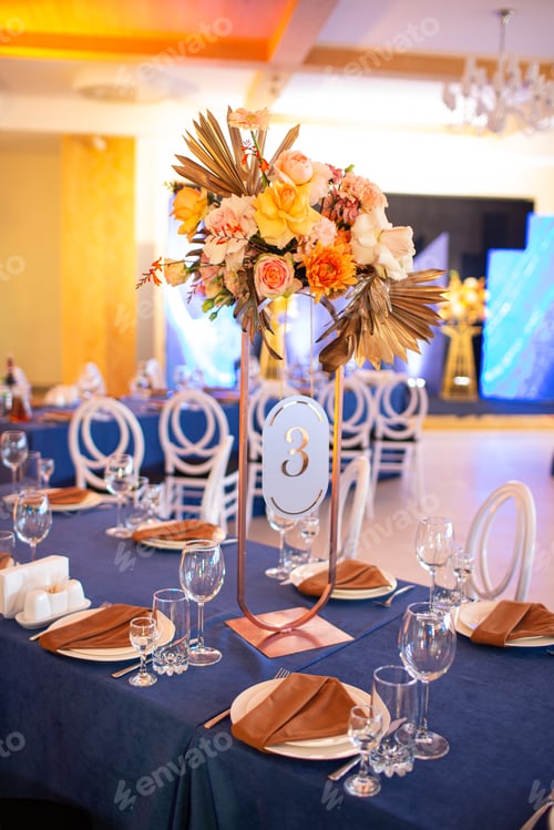 Preview: Festive table with blue cloth, napkins, plates, cutlery and glasses prepared for wedding guests