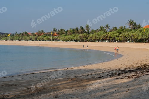 Preview: Beautiful tropical sunset scenery, two sun beds, loungers, umbrella under palm tree