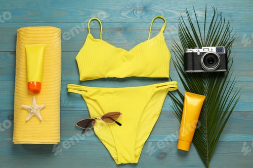 Preview: Different beach objects on light blue wooden background, flat lay