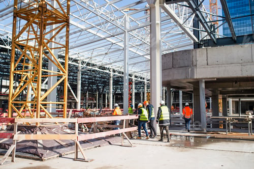 Preview: Group of engineers standing on construction site, talking
