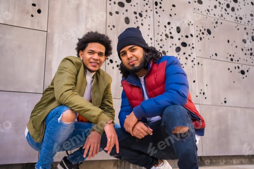 Preview: Urban style, portrait of two Latino black friends having fun in the street