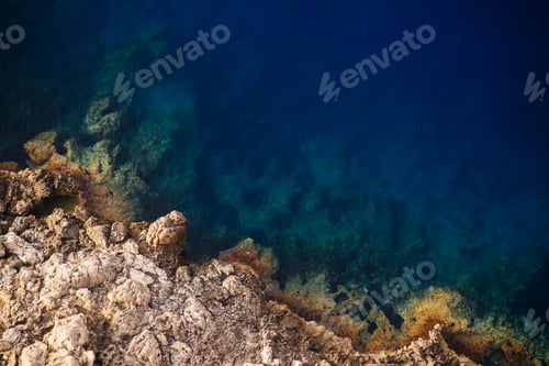Preview: Beautiful overhead shot of rocky cliffs of the sea on a sunny day