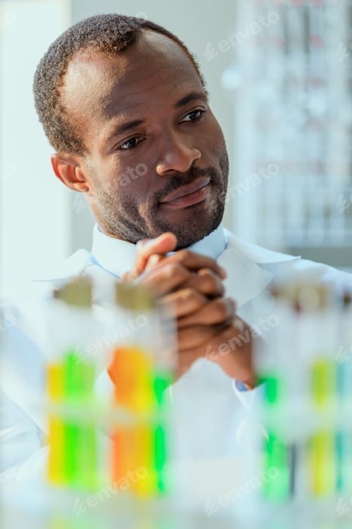 Preview: african american doctor in uniform sitting at testing laboratory, doctor concept