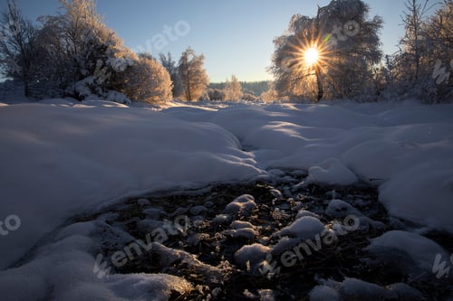 Preview: sunlight over river in ice and snow