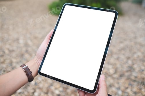 Preview: Mockup image of a woman holding digital tablet with blank white desktop screen in the outdoors