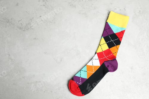 Preview: Pair of colorful socks on gray background with space for text