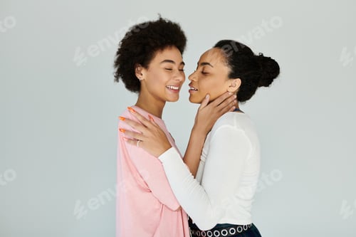 Preview: Intimate moment captured between two friends sharing smiles and warmth in a serene indoor space