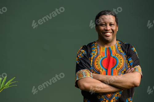 Preview: Portrait of handsome black man wearing traditional clothes with arms crossed while smiling