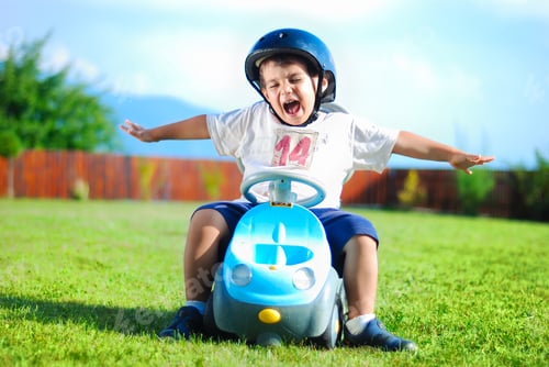 Preview: Happy Kid On Green Meadow Driving A Car