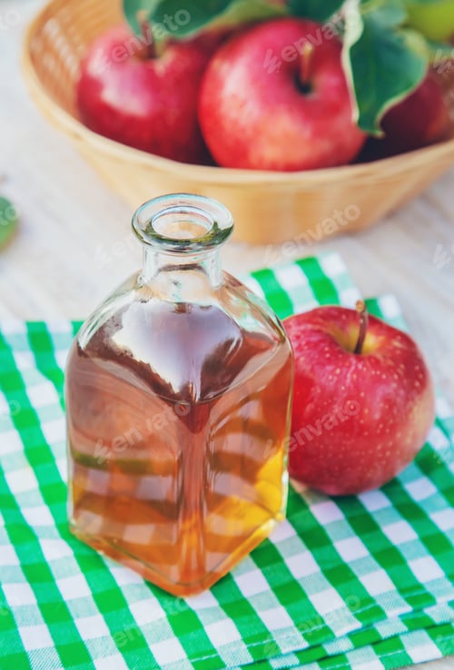 Preview: Apple cider vinegar in a bottle. Selective focus.