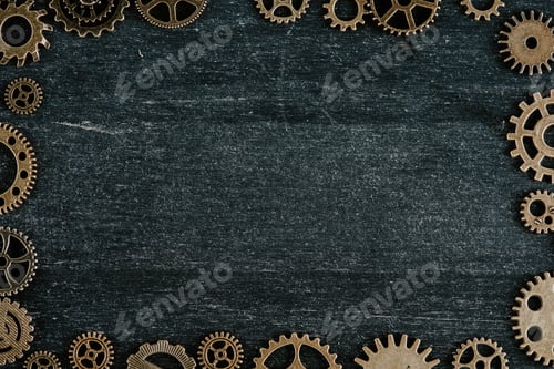 Preview: frame of vintage metal gears on dark wooden background with copy space