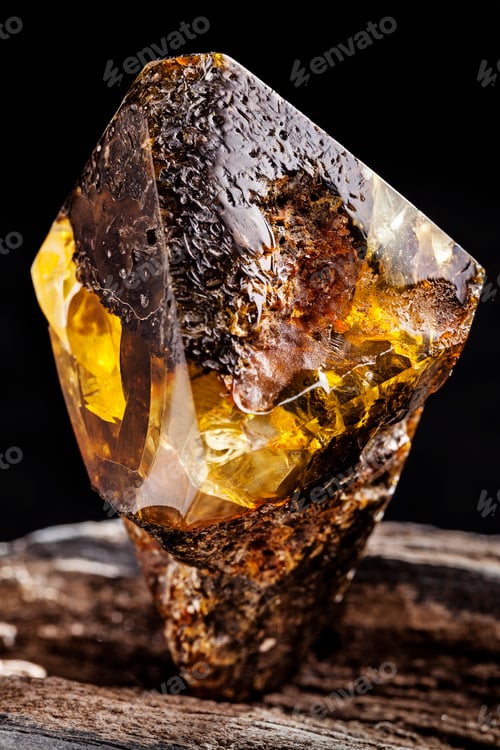 Preview: Natural amber stone. A piece of dirty amber with transparent yellow layer on piece of stoned wood