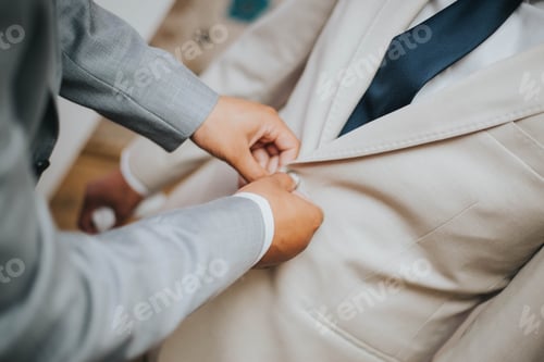 Preview: Man Buttons Light-Colored Blazer Before Event