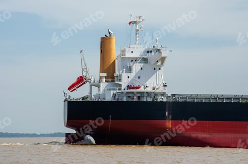 Preview: close up on a red and black cargo ship sailing on the water