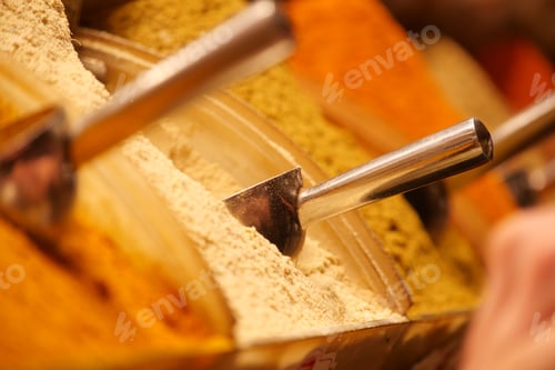 Preview: Vibrant spices in containers at a market stall