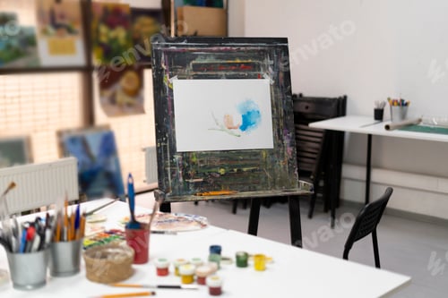 Preview: the artist's workplace in the studio with different paints and brushes