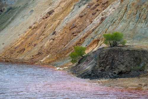Preview: Copper mine lake, colorful mining tailings landscape with red water and green trees