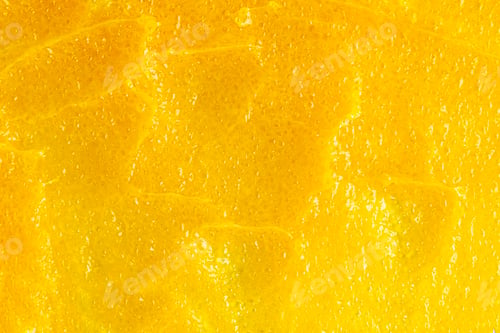 Preview: Texture of bright yellow mango body care scrub