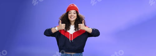 Preview: Girl totally agrees recommends cool place showing thumbs-up and smiling excited with happy grin