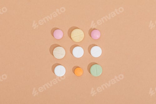 Preview: Flat lay with colorful pills on brown surface