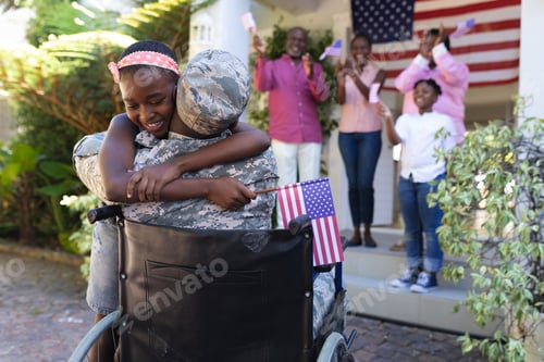 Preview: African american soldier father in wheelchair hugging daughter three generation family behind