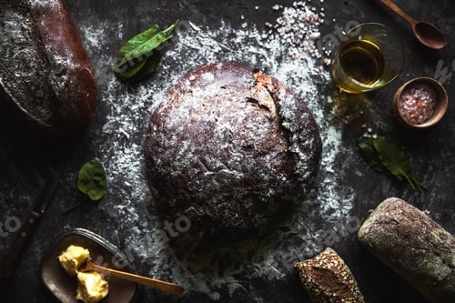 Preview: Bread on a black background. Homemade pastries with ingredients