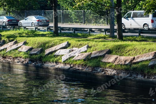 Preview: Riverbank infrastructure upkeep in city area. Granite embankment restoration on riverbank with slabs