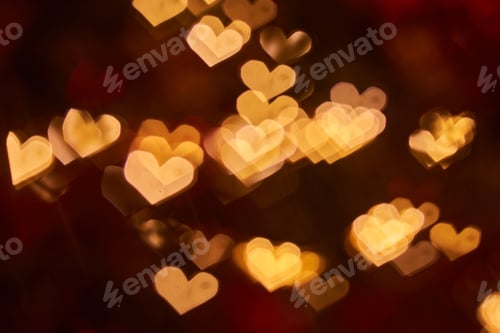Preview: Blurred view of heart shaped lights on black background.