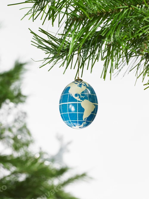 Preview: Globe christmas bauble hanging on a pine tree branch.