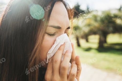 Preview: The girl blows her nose in a handkerchief, close-up