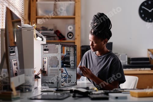 Preview: African American Woman Repairing System Unit of Computer in Workshop