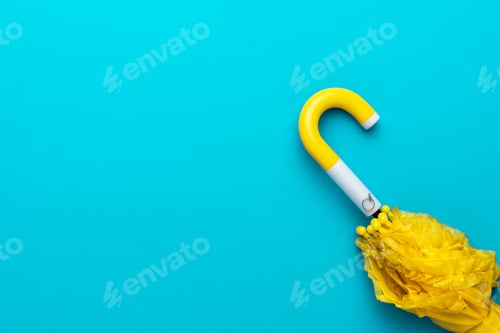 Preview: Folded Yellow Umbrella on Turquoise Blue Background