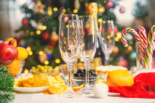 Preview: Christmas table with champagne and food. Selective focus.