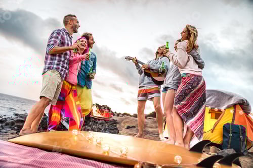 Preview: Young friends having fun at beach camping party