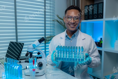 Preview: a chemist or scientific researcher looks at the camera while in a lab, a highly skilled scientist wo