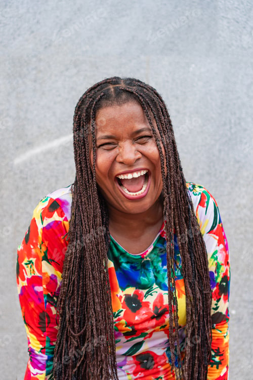 Preview: Older woman with braids laughs in the street