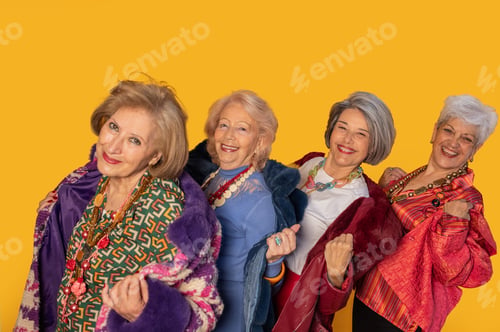 Preview: Four stylish senior women showing off their fashion sense on yellow background