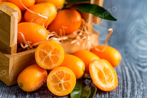 Preview: Kumquat or cumquat on wooden table