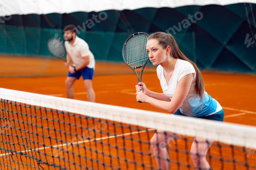 Preview: Pair of tennis players, man and woman waiting for service at indoor court