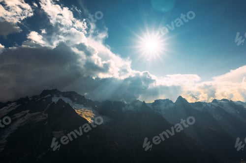 Preview: The sun's rays Shine on the Caucasus mountains. Snow-capped mountains under the sun