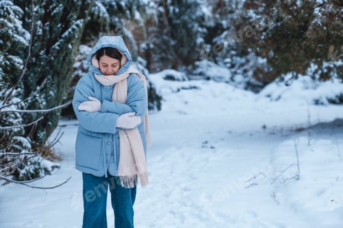 Preview: portrait of the woman get frozen outdoors at cold winter day