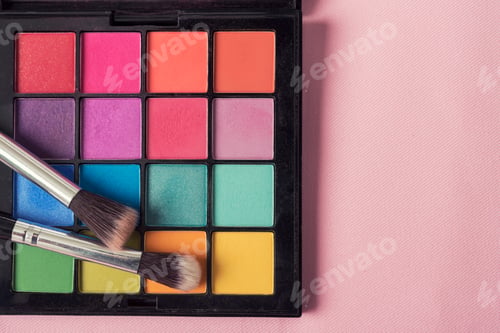 Preview: Beautiful makeup background. Makeup brush on colorful makeup palette with copyspace.