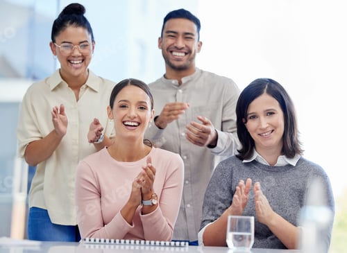 Preview: Portrait of a group of young businesspeople clapping during a conference in a modern office